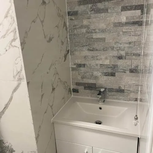 Vanity basin with stone-effect feature wall tiles